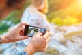 Hands holding the phone and taking pictures of the girl on the phone Royalty Free Stock Photo