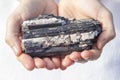 Hands holding piece of Black Tourmaline Royalty Free Stock Photo