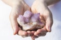 Hands holding piece of Spirit Quartz