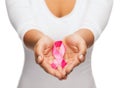 Hands holding pink breast cancer awareness ribbon Royalty Free Stock Photo