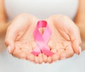 Hands holding pink breast cancer awareness ribbon Royalty Free Stock Photo