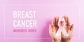 Hands holding pink ribbons, Breast cancer awareness, symbolic bow color raising awareness on women`s breast tumor. Healthcare, Royalty Free Stock Photo
