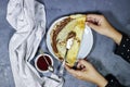 hands holding a plate of Crepes stuffed with chocolate spread on blue plate with fig jam bowl Royalty Free Stock Photo