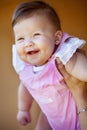 Hands, holding and portrait of a baby for playing, laughing and bonding with a parent in a house. Happy, playful and a Royalty Free Stock Photo