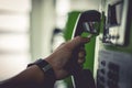 Hands that are holding a public phone to call emergency Royalty Free Stock Photo