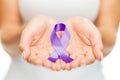 Hands holding purple awareness ribbon Royalty Free Stock Photo