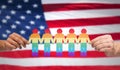 Hands holding rainbow people over american flag Royalty Free Stock Photo