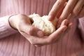 Teenage girl holding raw shea butter or karite in her hands