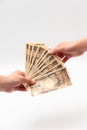 Hands holding receiving / paying 100,000 yen.  on white background. Royalty Free Stock Photo