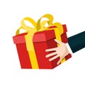 Hands Holding Red Gift Box with Gold Bow Royalty Free Stock Photo