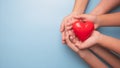 Hands holding a red heart on blue background, CSR or Corporate Social Responsibility Royalty Free Stock Photo