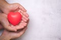 Hands holding a red heart, CSR or Corporate Social Responsibility, health care, family insurance Royalty Free Stock Photo