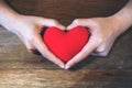 Hands holding a red heart sign Royalty Free Stock Photo