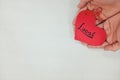 Hands holding a red heart tag with handwritten word local. Support, promote, buy, shop and love local business concept. Royalty Free Stock Photo