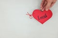 Hands holding a red heart tag with written word local. Support, promote, buy, shop and love local business concept.