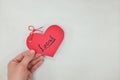 Hands holding a red heart tag with written word local. Support, promote, buy, shop and love local business concept. Royalty Free Stock Photo