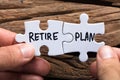 Hands Holding Retire Plan Matching Jigsaw Pieces