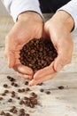 Hands holding roasted coffee beans Royalty Free Stock Photo