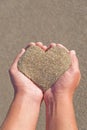 Hands holding a sand in form of heart Royalty Free Stock Photo