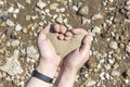 Hands holding a sand in the palms of heart,the concept of life running out like sand through fingers Royalty Free Stock Photo