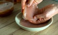 Hands holding scoby. Probiotic fermented drink