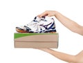 Hands holding shoes in a box Royalty Free Stock Photo