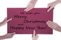 Hands Holding Sign with Christmas Greetings Royalty Free Stock Photo