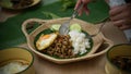 Hands holding silverware eating Thai traditional food, Stir fried minced pork with basil Pad ka prao, rice fried egg serving on Royalty Free Stock Photo