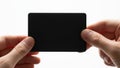 Hands holding a sleek black rectangular object against a white background Royalty Free Stock Photo