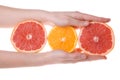 Hands holding sliced orange and grapefruit Royalty Free Stock Photo