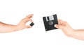 Hands Holding Small Memory Card Versus Old Floppy Disk