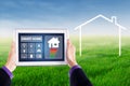 Hands holding smart house controller at field Royalty Free Stock Photo