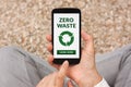 Hands holding smart phone with zero waste concept on screen Royalty Free Stock Photo