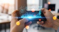 Hands holding a smartphone displaying a futuristic digital interface with glowing data visualizations and bright lights Royalty Free Stock Photo