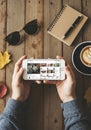 Hands holding a smartphone displaying a social media app interface. The setting Royalty Free Stock Photo
