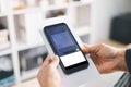 Hands holding smartphone scanning paper document with mobile app interface, digital verification for fintech onboarding, QR check- Royalty Free Stock Photo