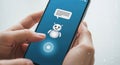 Hands holding smartphone showing ai chatbot interface with text bubble and friendly robot icon Royalty Free Stock Photo