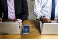 Hands holding a smartphone with sync symbol on screen