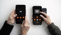 Hands holding smartphones displaying digital interface app control Royalty Free Stock Photo