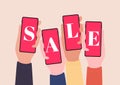 Hands holding smartphones and show SALE. Online shopping with mobile phones.