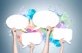 Hands holding speech bubbles, colorful wall Royalty Free Stock Photo