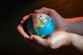 hands holding split earth model Royalty Free Stock Photo