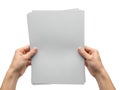 Hands holding a stack of blank gray paper sheets Royalty Free Stock Photo