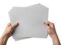 Hands holding a stack of blank gray paper sheets Royalty Free Stock Photo