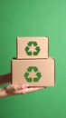 Hands Holding Stack of Recycled Cardboard Boxes Eco Conscious Lifestyle Green Background Royalty Free Stock Photo