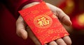 Hands holding a stack of red envelopes (Angpao) with the Chinese character 'Fu' (Fortune Royalty Free Stock Photo