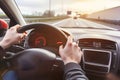 Hands holding on steering wheel while driving Royalty Free Stock Photo