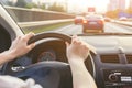 Hands holding on steering wheel while driving Royalty Free Stock Photo