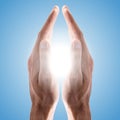 Hands holding sun in blue sky Royalty Free Stock Photo