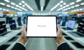 Hands holding a tablet with a blank white screen, perfect for copy space in a tech store Royalty Free Stock Photo